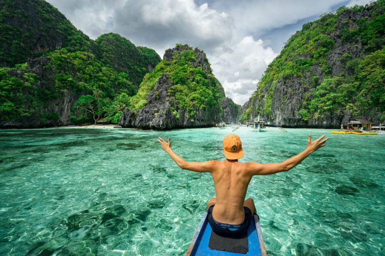 a man on a boat in the middle of a body of water.