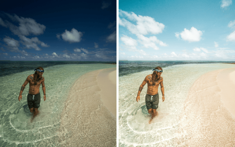 a man standing in the ocean next to a sandy beach.