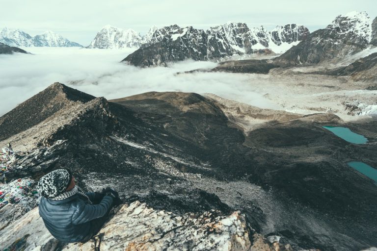 a person sitting on top of a mountain.