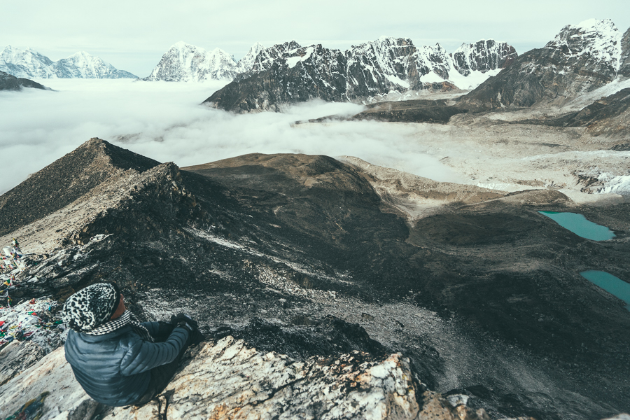 a person sitting on top of a mountain.