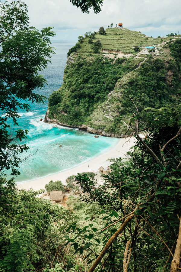 a view of a beach from the top of a hill.