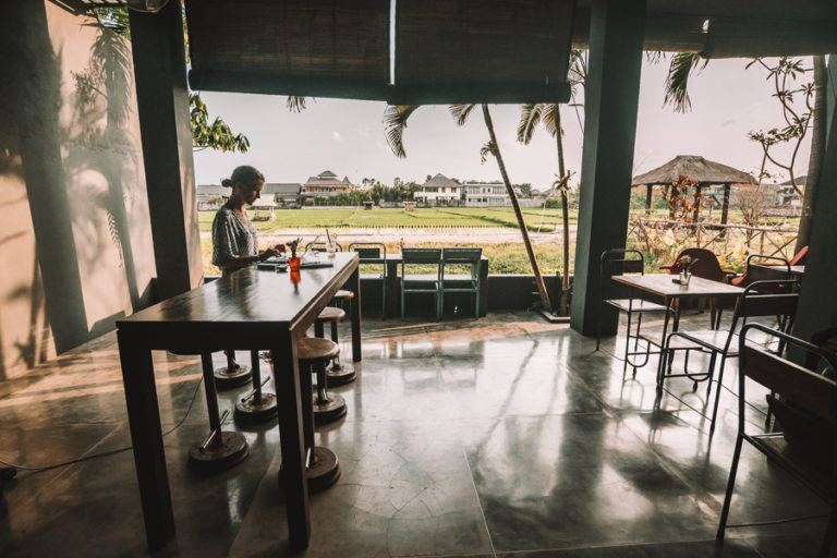 a person sitting at a table in a restaurant.