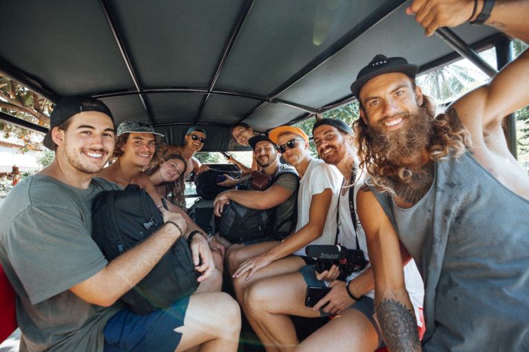 a group of people riding on the back of a bus.