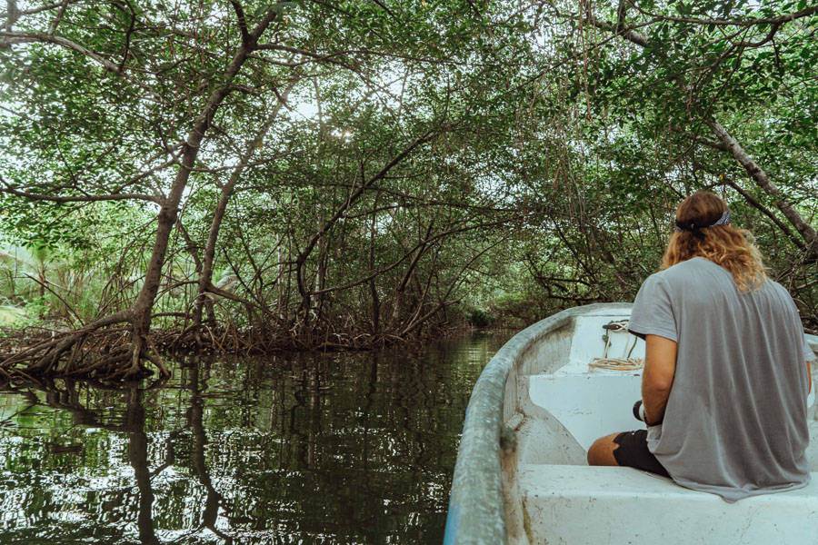 a woman sitting in a boat on a river.