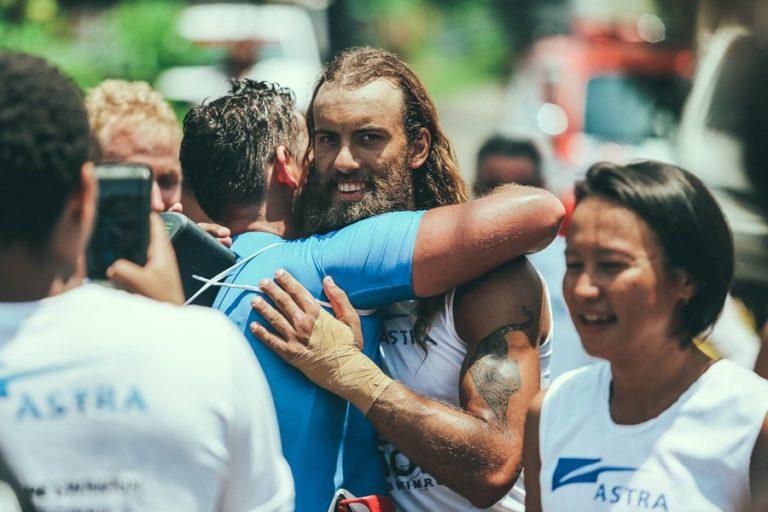 a man with a beard hugging another man.