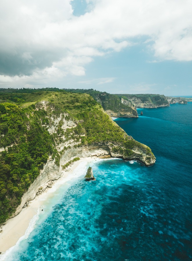 an aerial view of a beach and a cliff.
