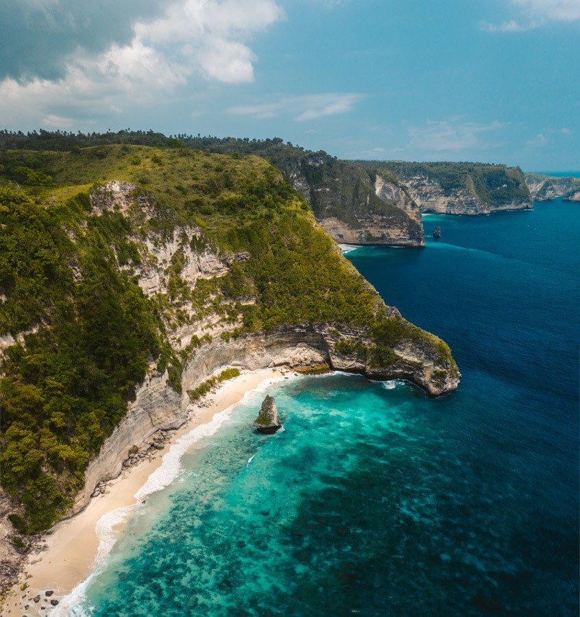 an aerial view of a beach and a cliff.