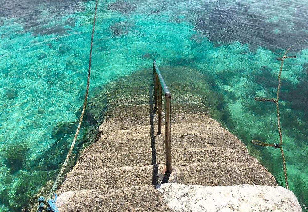 a set of stairs leading down to the water.