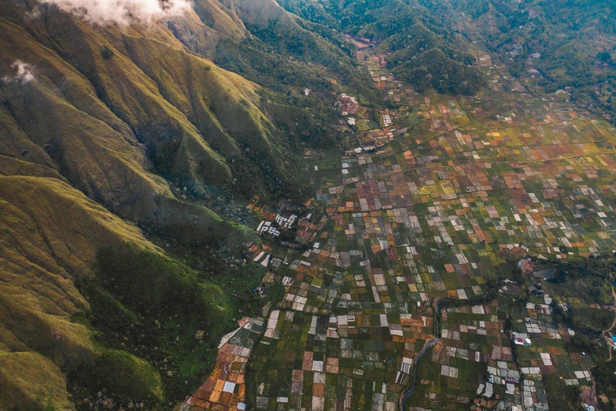 an aerial view of a small town in the mountains.