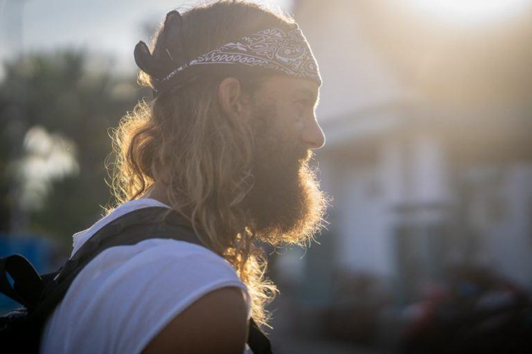 a man with long hair wearing a bandana.