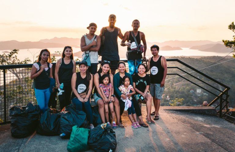 a group of people standing on top of a mountain.