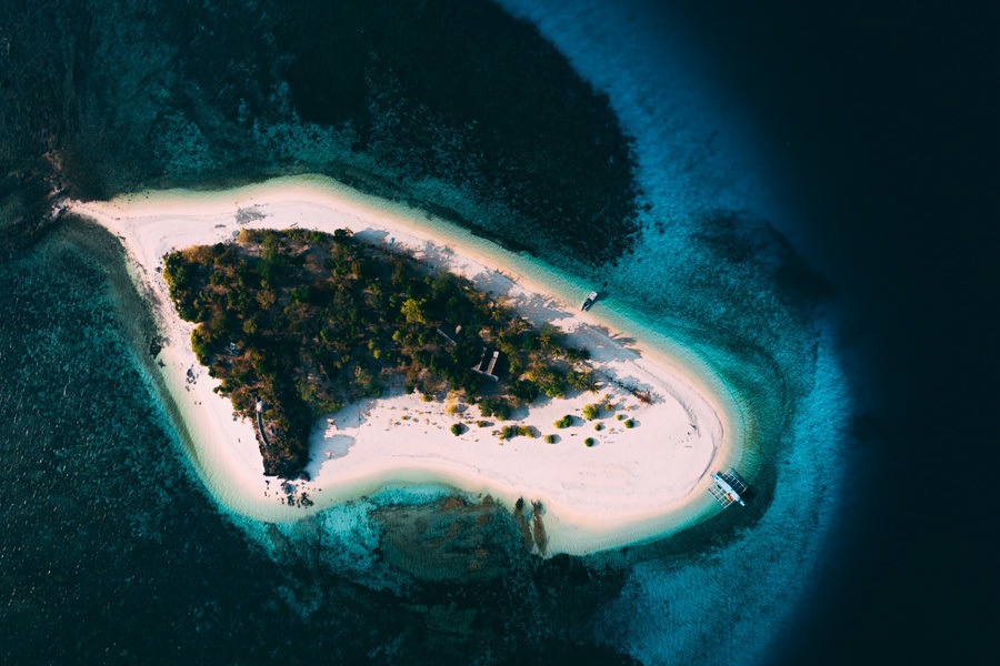 an aerial view of a small island in the middle of the ocean.