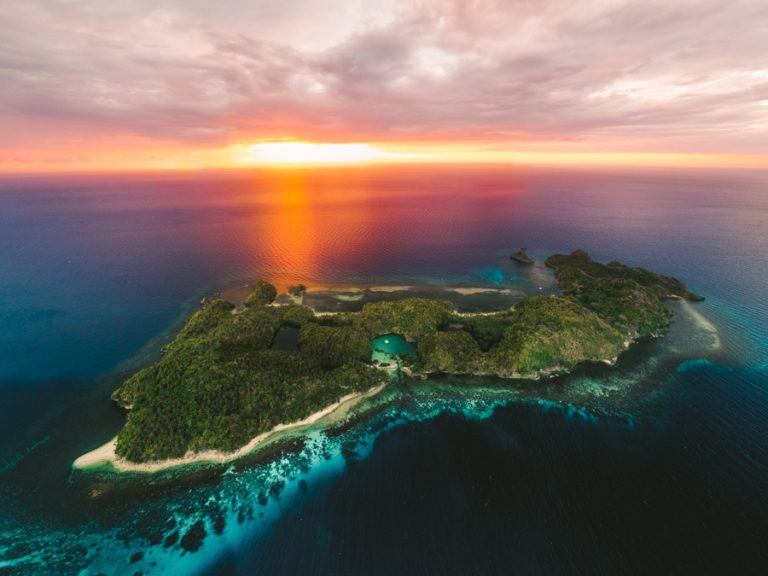an aerial view of a small island in the middle of the ocean.
