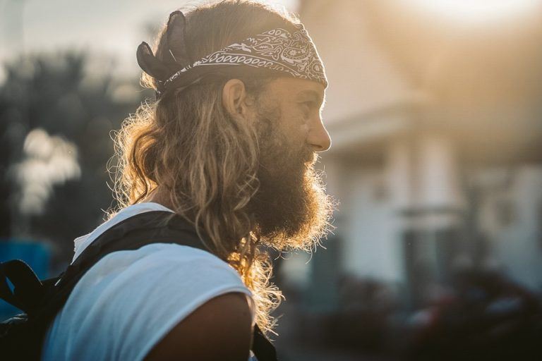 a man with long hair wearing a bandana.