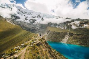 a view of a mountain with a lake in the foreground.
