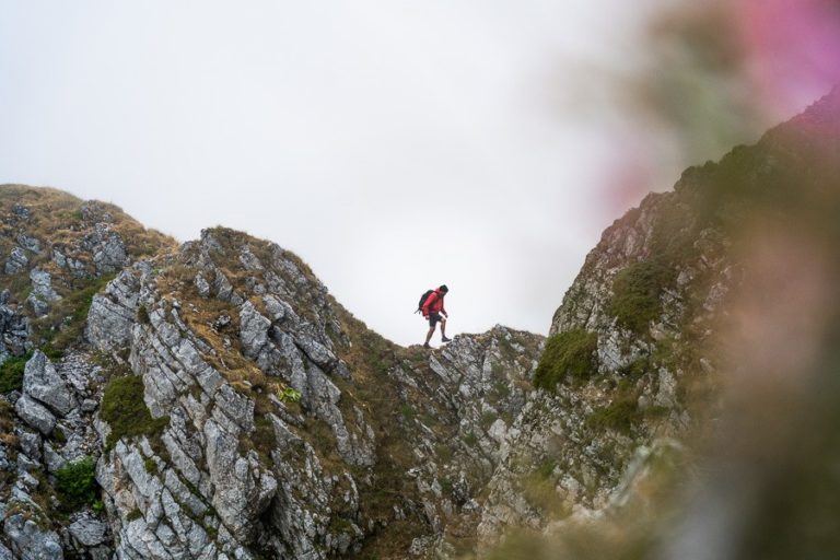 a person on a mountain with a backpack.