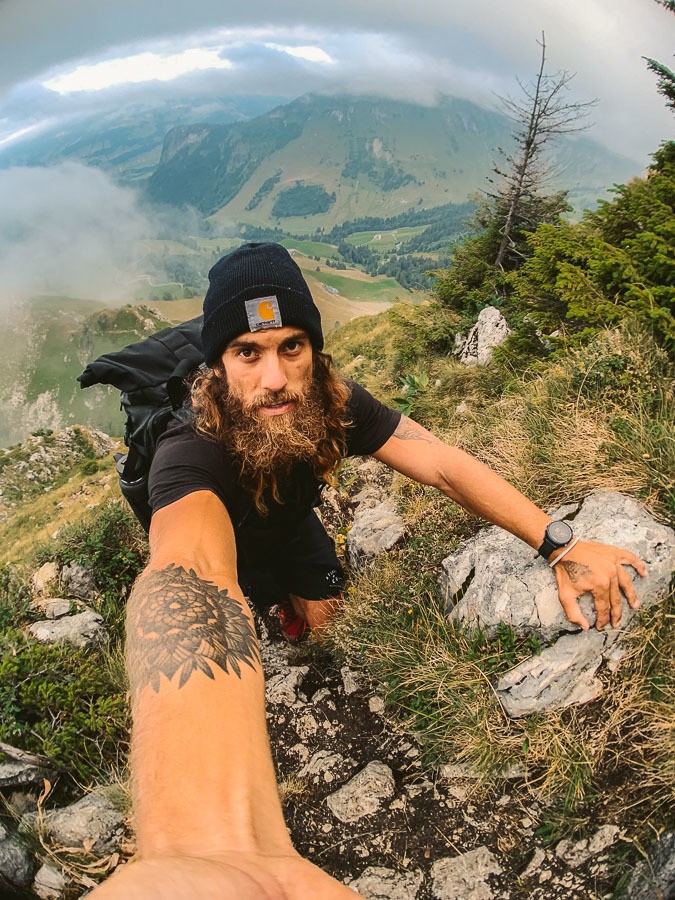 a man taking a selfie on a mountain.