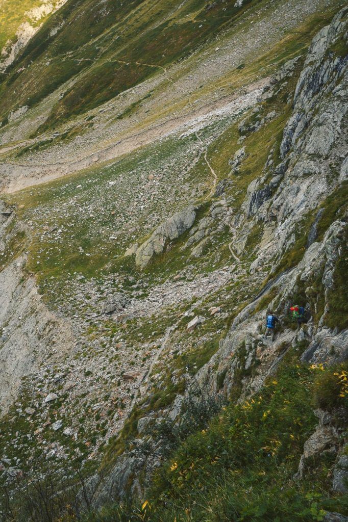 a group of people hiking up a steep hill.