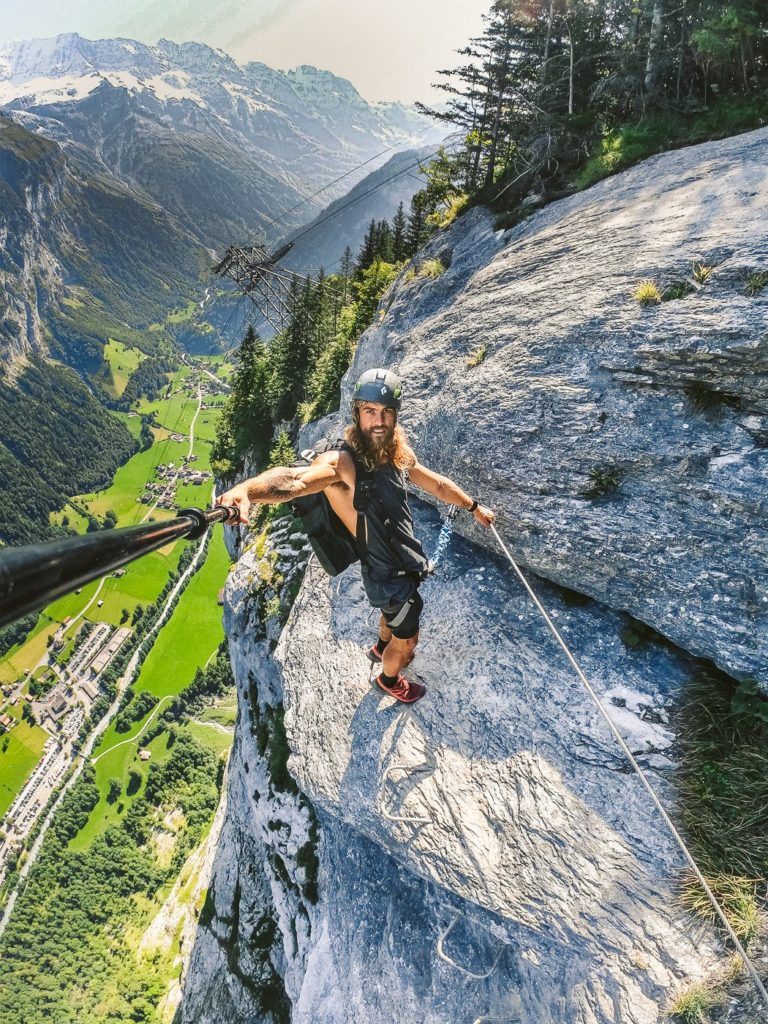 a man on a rope on top of a mountain.