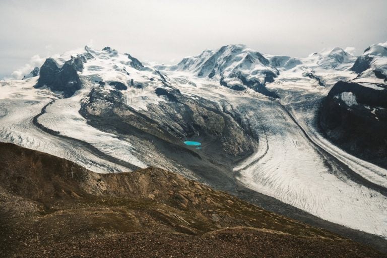 a blue lake in the middle of a mountain.