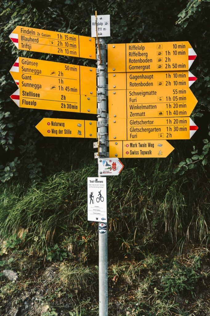 a pole with a bunch of signs on it.