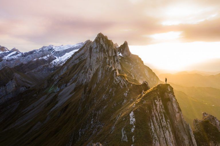a person standing on top of a mountain.