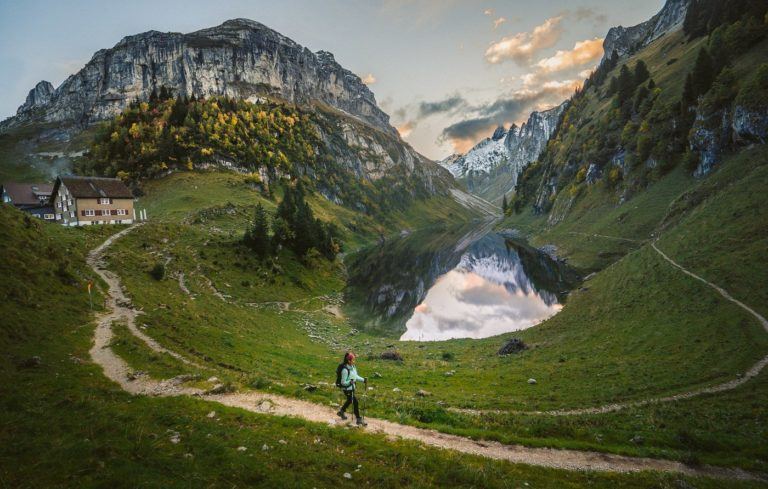 a person walking on a trail in the mountains.