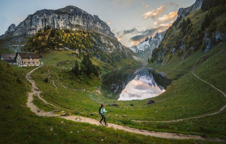 a person walking on a trail in the mountains.