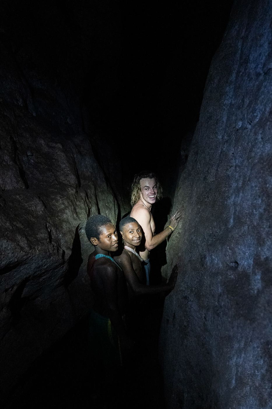 a couple of people that are standing in a cave.