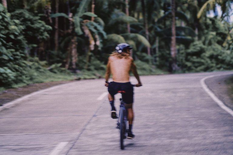 a person riding a bike down a road.