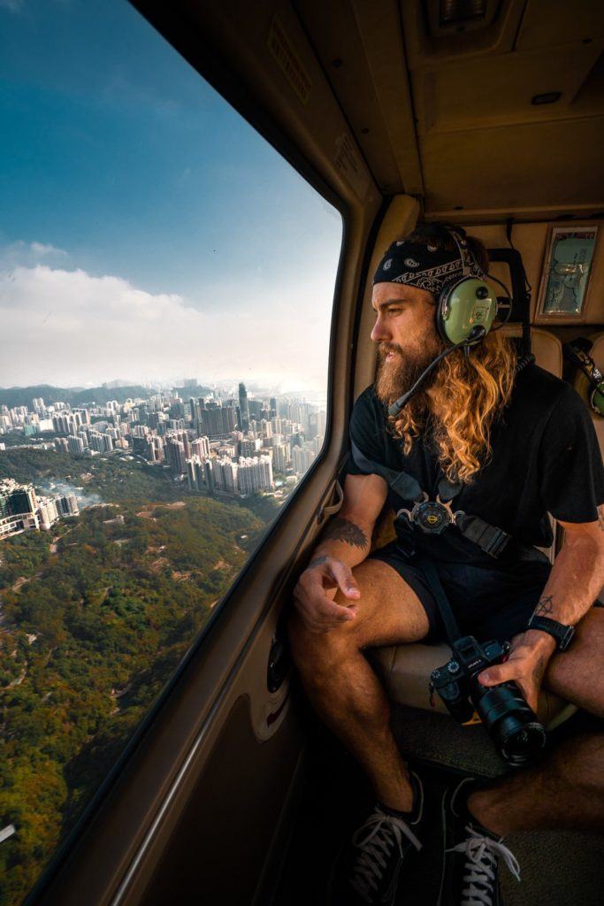 a man sitting in a helicopter looking out the window.