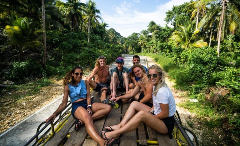 a group of people riding in the back of a truck.