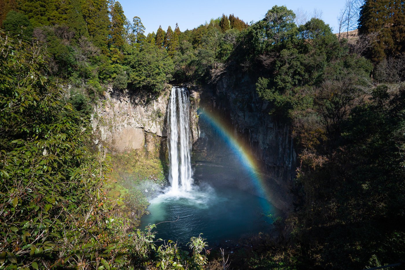 a waterfall with a rainbow in the middle of it.