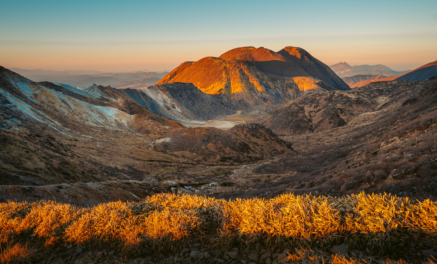 a view of a mountain range at sunset.