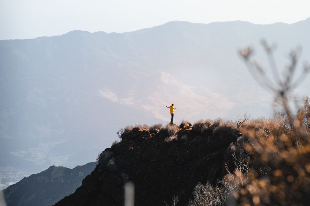 a person standing on top of a mountain.