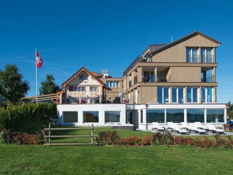 a large building with a lawn in front of it.