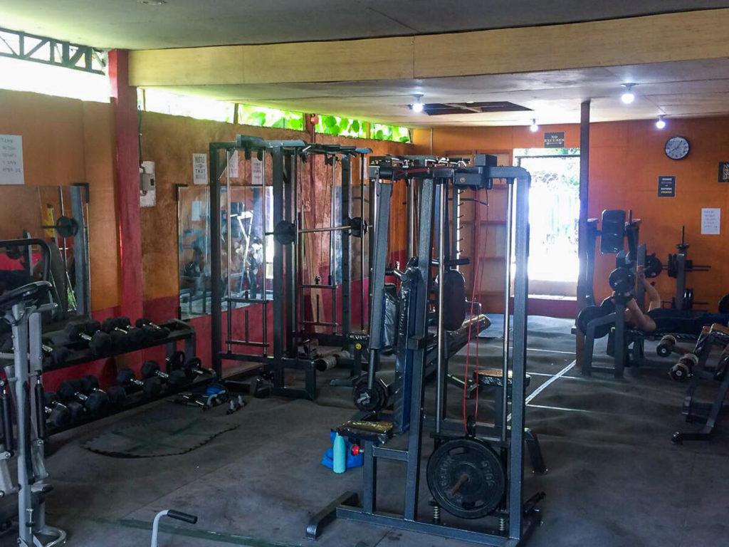 a gym with a lot of equipment in it.