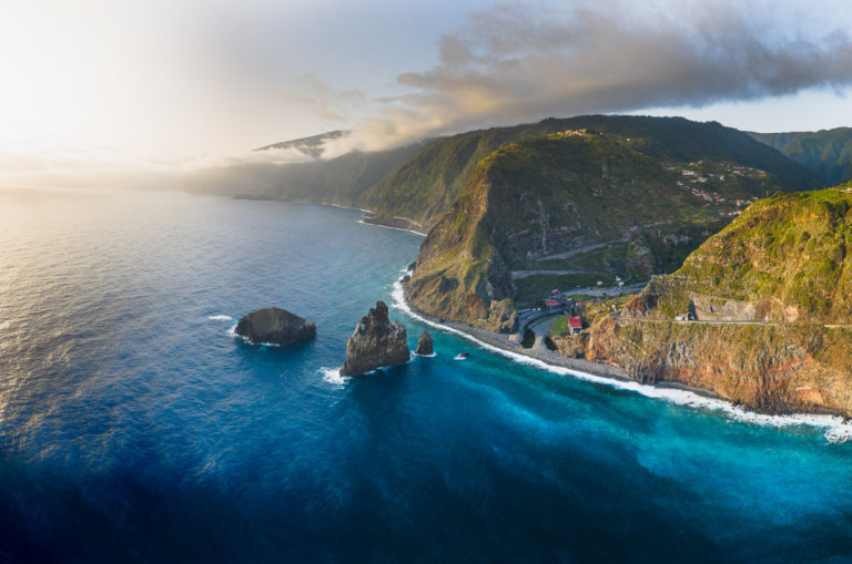 an aerial view of the ocean and cliffs.
