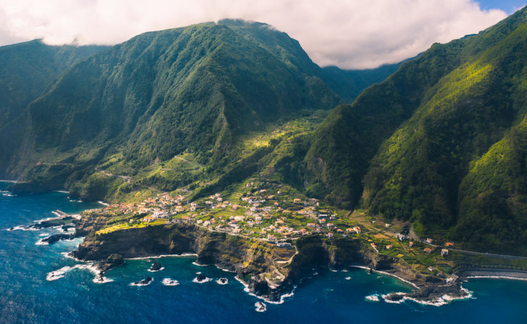 an aerial view of a small village in the middle of the ocean.