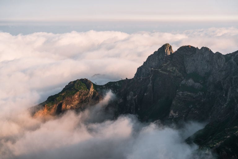 a view of a mountain with a few clouds.