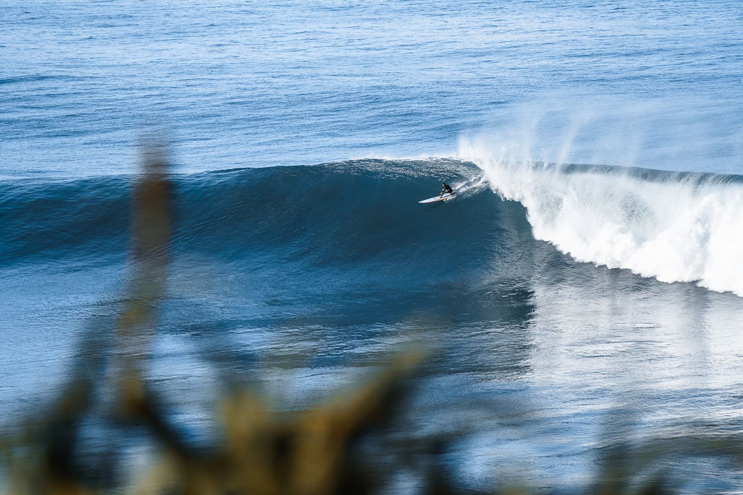 a surfer riding a wave in the ocean.