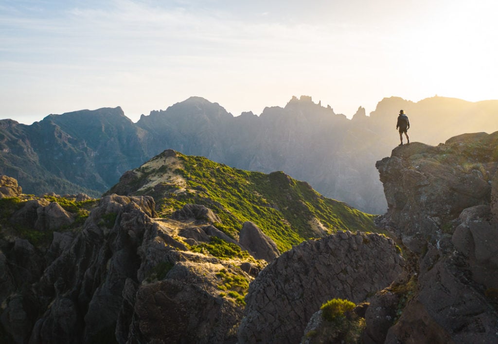 a person standing on top of a mountain.