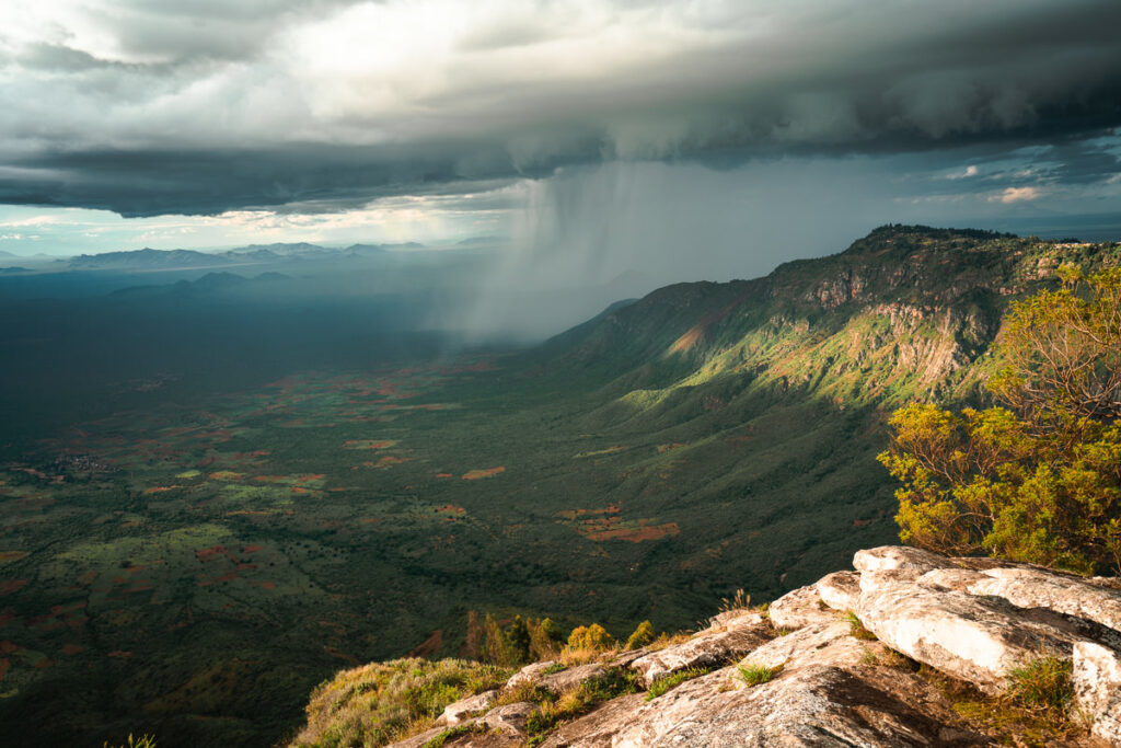 a view of a mountain range with a storm coming in