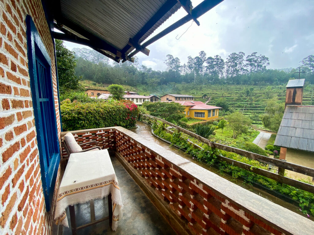 a balcony with a view of a tea plantation