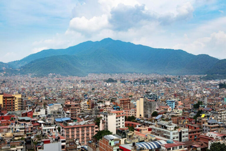 a view of a city with mountains in the background