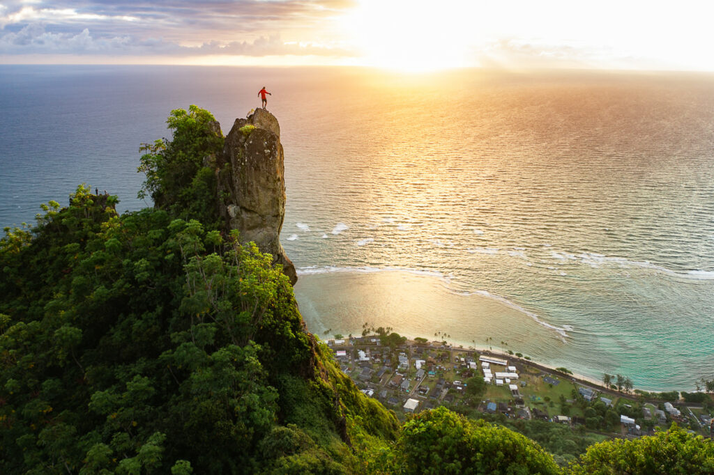 a person standing on top of a cliff overlooking the ocean