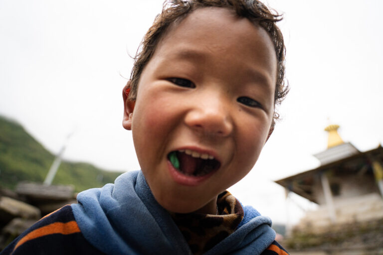 a young boy with a toothbrush in his mouth