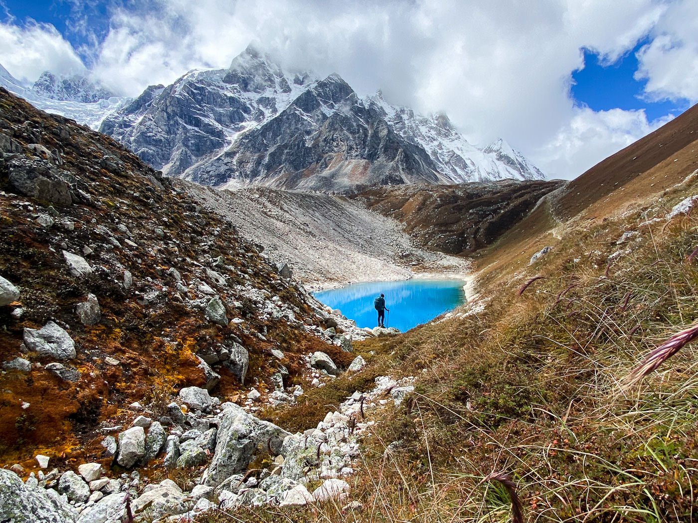 a person walking up a hill near a body of water