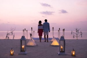 a man and a woman standing on a beach