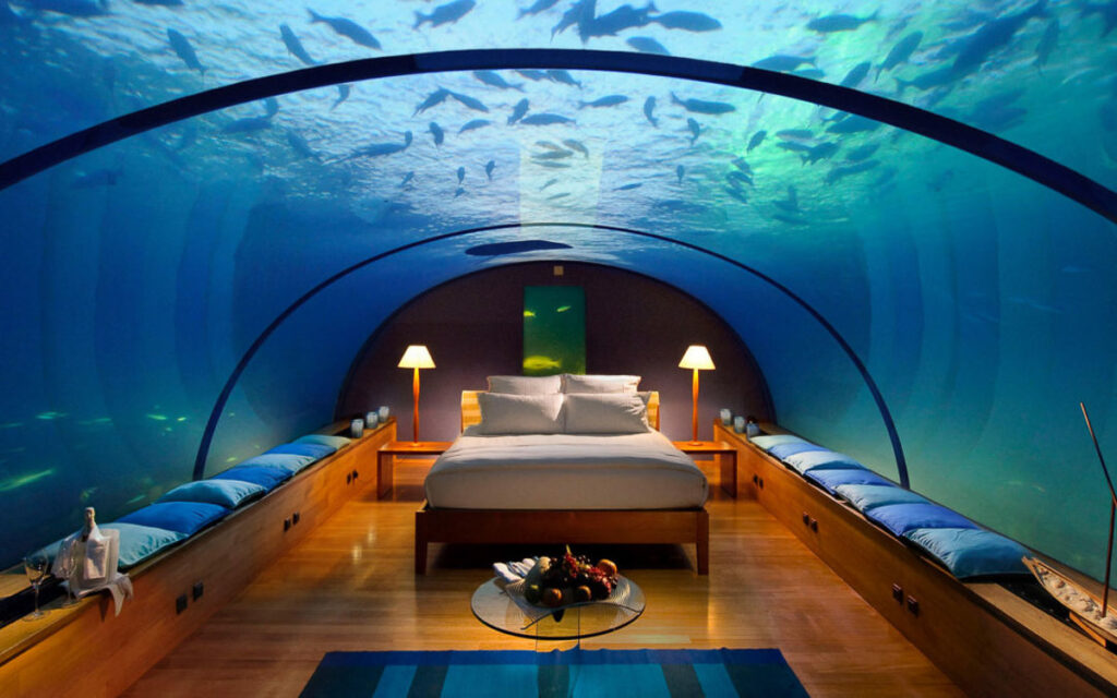 a room with a bed and a fish tank